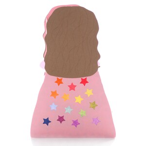 May include: A pink felt doll with brown hair and a rainbow star pattern on the skirt.