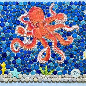 May include: A colorful mosaic tile artwork depicting an orange octopus with white spots surrounded by blue and white round tiles. The octopus is in the center of the image and has its tentacles spread out. There are also some small white fish and a starfish in the image.