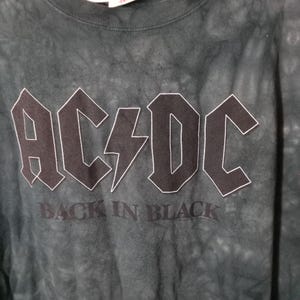 May include: Dark green tie-dye t-shirt featuring the band name "AC/DC" in black block letters with a white outline, and a lightning bolt graphic. Below the band name is the text "BACK IN BLACK".