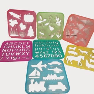 May include: A collection of colorful plastic stencils in various shapes. Includes stencils with letters, numbers, and shapes like a pumpkin, tree, and airplane. Ideal for crafts and educational activities.