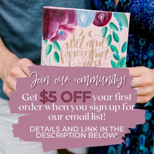 May include: Two hands holding a pink canvas with floral designs and gold lettering that reads "Be still and know that I am". The image has a pink overlay with the text "Join our community! Get $5 OFF your first order when you sign up for our email list! DETAILS AND LINK IN THE DESCRIPTION BELOW!"