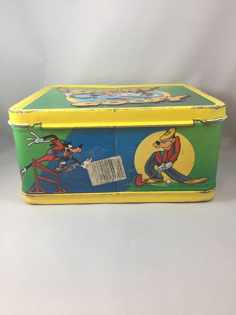 May include: A yellow metal lunchbox with a green, blue, and white image of Goofy playing golf and running a hurdle race. The lunchbox has the words "Goofy Goofy" on the top.