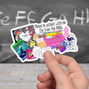 May include: A sticker sheet with a variety of 90s themed images, including a composition book, a pencil, a cassette tape, a game of 'Space Invaders', a paper fortune teller, and a yin yang symbol. The sticker sheet has the text 'Please be patient with me I'm from the 1990s'.