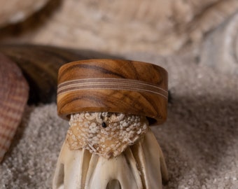 Exceptional ring made of olive wood. Multiple layers of glued birch wood are incorporated in the middle.