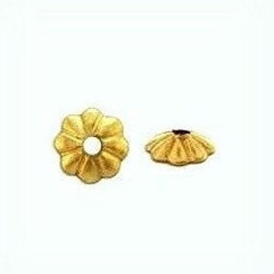 May include: Gold-toned metal bead with a flower-shaped design. The bead has a hole in the center for stringing.