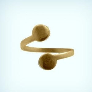 May include: A gold-toned adjustable ring with two round, flat, smooth, circular accents.