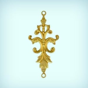 May include: Gold-toned metal pendant with a decorative, ornate design. The pendant has two loops at the top and bottom for attaching to a chain or cord.