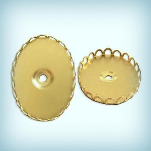 May include: Two gold-colored metal embellishments with scalloped edges. The embellishments are round and have a hole in the center.