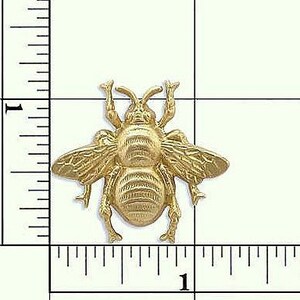 May include: Gold-toned metal bee charm with detailed wings and legs. The bee is approximately 2.5 cm in size.
