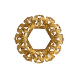 May include: A gold-colored, ornate metal component with a hexagonal shape and intricate openwork design. The decorative piece features repeating floral and scroll patterns, creating a vintage or antique aesthetic. The object is isolated on a white background.