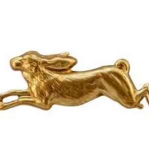 May include: A gold-colored metal rabbit figurine in a running pose. The rabbit is detailed with textured fur and has long ears.