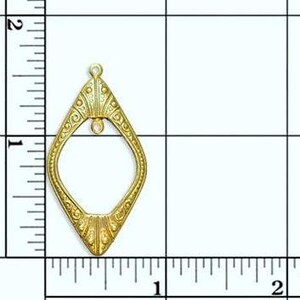 May include: Gold-toned metal pendant with a diamond-shaped frame and intricate details. The pendant measures approximately 1 inch in height.