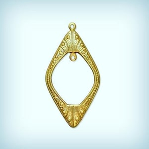 May include: A gold-colored metal pendant in the shape of a diamond with intricate details and a small loop at the top.
