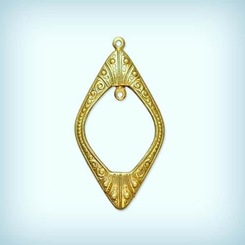 May include: A gold-colored metal pendant in the shape of a diamond with intricate details and a small loop at the top.