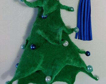 May include: A handmade green felt Christmas tree ornament with pearl and blue bead accents. A blue tassel hangs from the top, and the artist's signature is in the bottom right corner. This festive decoration is perfect for the holiday season.