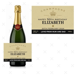 May include: A champagne bottle with a gold foil neck wrap and a red crown seal. The label is beige with black text reading CHAMPAGNE, HAPPY 50TH BIRTHDAY ELIZABETH, 20TH FEBRUARY 2024, LOVE FROM MUM AND DAD, ALC 12% BY VOL, and 750ML.