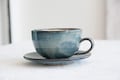 Pottery Cappuccino Cup and Saucer, Blue and White product logo