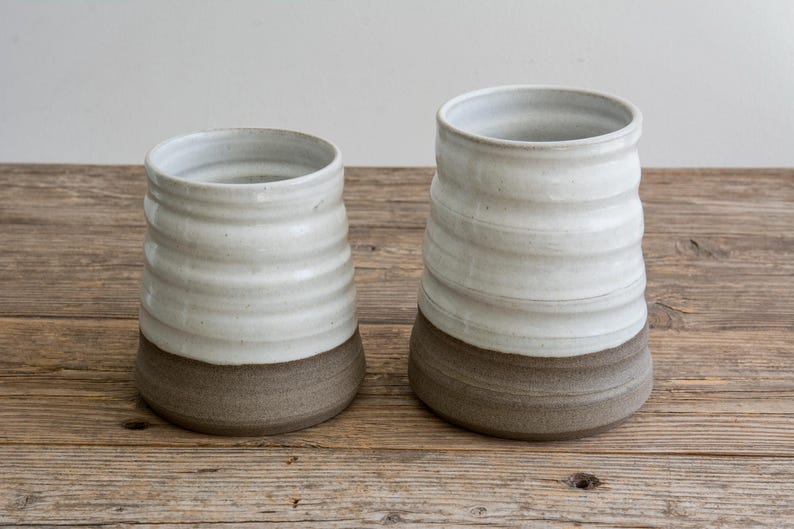 French country crock used as a floral centerpiece on a dining table.