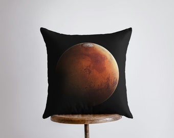 May include: A black throw pillow with a large, detailed image of Mars, the red planet, in the center.