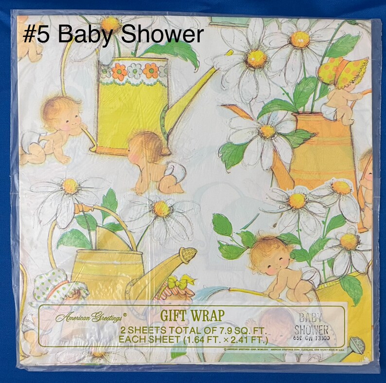 May include: Baby shower gift wrap featuring a white background with a repeating pattern of yellow watering cans, daisies, and babies. The text "#5 Baby Shower" is in the top left corner. The text "GIFT WRAP" is in the center of the image. The text "BABY SHOWER" is in the bottom right corner. The text "2 SHEETS TOTAL OF 7.9 SQ. FT. EACH SHEET (1.64 FT. x 2.41 FT.)" is in the center of the image.