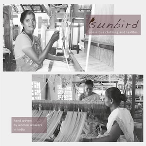 May include: Black and white photo of women weaving on looms in a workshop. The text "Sunbird conscious clothing and textiles" is visible in the top right corner. The text "hand woven by women weavers in India" is visible in the bottom left corner.