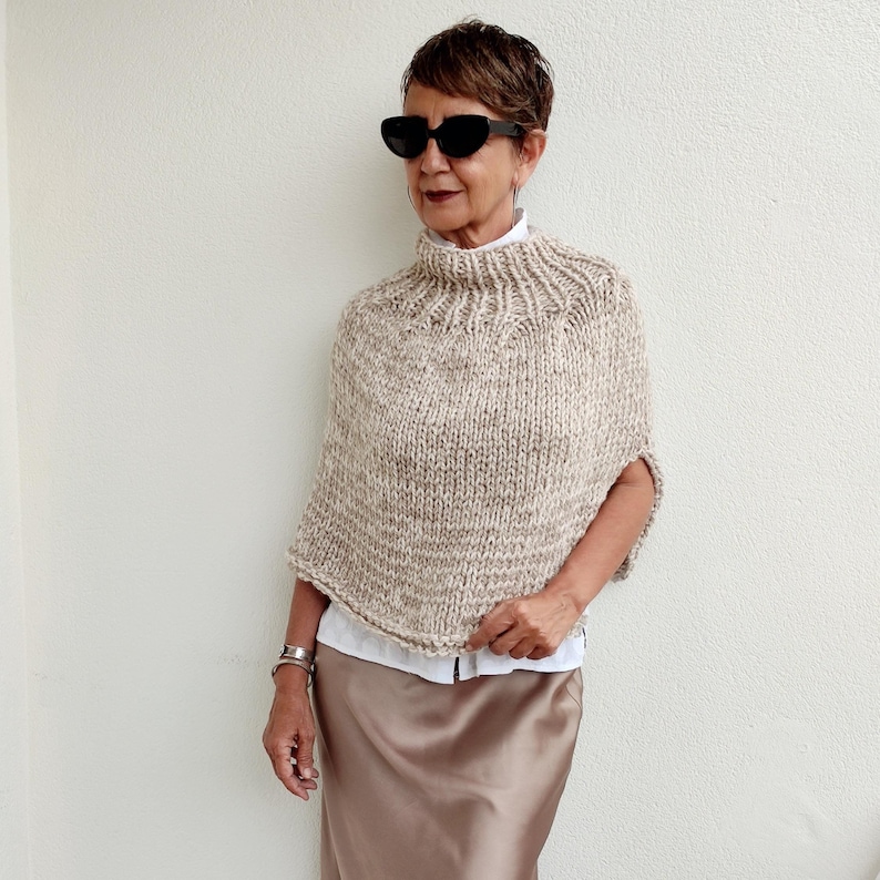 Stylish neutral wool poncho for women. Hand knitted beige turtleneck women poncho