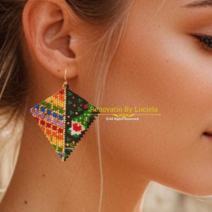 May include: Diamond-shaped beaded earrings with a gold hook. The earrings are divided into two sections, one with a colorful geometric pattern and the other with a floral design. The text "Renovatio By Luciela" is visible.