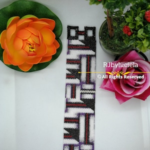 May include: A black, white, red and purple beaded bracelet with a geometric pattern. The bracelet has silver metal clasps on each end. ©All Rights Reserved RJbyluciela