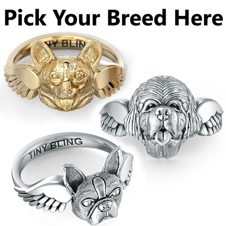 K&ouml;nnte beinhalten: Drei silberne und goldene Ringe mit Hunderassen. Die Ringe haben Fl&uuml;gel an der Seite. Die Ringe sind mit "Tiny Bling" beschriftet. W&auml;hlen Sie Ihre Rasse hier.