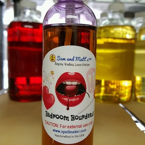 May include: A brown glass bottle with a purple cap and a spray nozzle. The bottle has a label with a red and white illustration of a mouth with a cherry inside. The label also includes the text "Sam and Matt's Bayou Vodou Love Potion Bedroom Bourdeaux CAUTION: For external use only www.spellmaker.com Handcrafted in the USA".