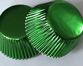 May include: Two green metallic cupcake cases. The cases are fluted and have a shiny finish.