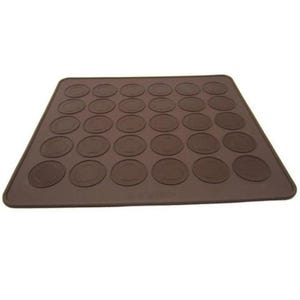 May include: A brown silicone baking mat with multiple circular indentations for making macarons. The mat is rectangular and designed to help bakers create uniform-sized cookies. The surface is smooth, and the indentations are slightly raised.