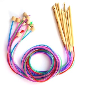 May include: A set of colorful circular knitting needles and a set of wooden crochet hooks. The knitting needles are made of plastic and have wooden tips. The crochet hooks are made of wood and have a variety of sizes.