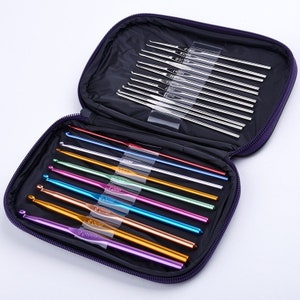 May include: A purple zippered case containing a set of crochet hooks. The hooks are in various colors, including silver, blue, green, and gold. The case is open, revealing the hooks neatly arranged inside. The hooks are made of metal.