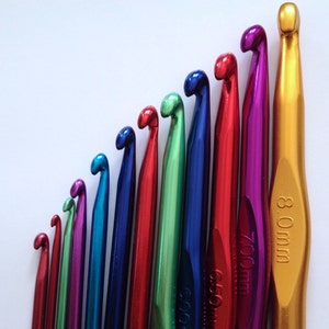 May include: A set of ten colorful crochet hooks, ranging in size from 2.5 mm to 8.0 mm. The hooks are made of metal and have a shiny finish.