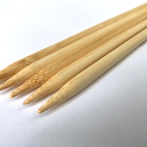 May include: Five natural bamboo knitting needles with pointed tips.