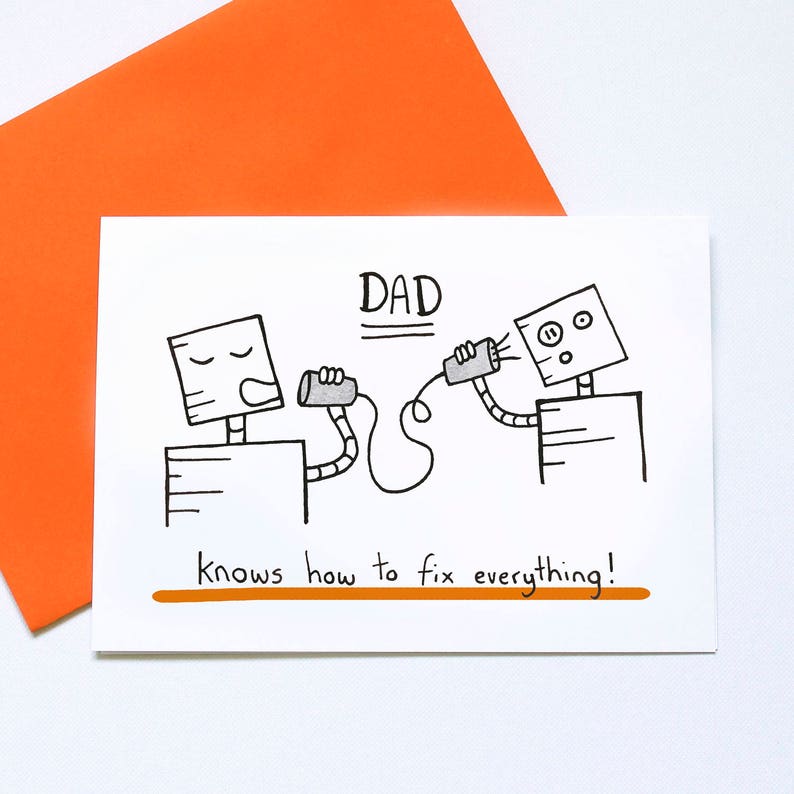 May include: A white greeting card with the word "DAD" above a drawing of two robot figures holding tin can phones. The text "knows how to fix everything!" is below the robots. An orange envelope is behind the card.