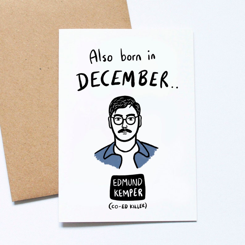 May include: A white greeting card with a brown envelope. The card features the text "Also born in DECEMBER.." above a black and white illustration of a man wearing glasses and a mustache. Below the illustration is the text "EDMUND KEMPER (CO-ED KILLER)".