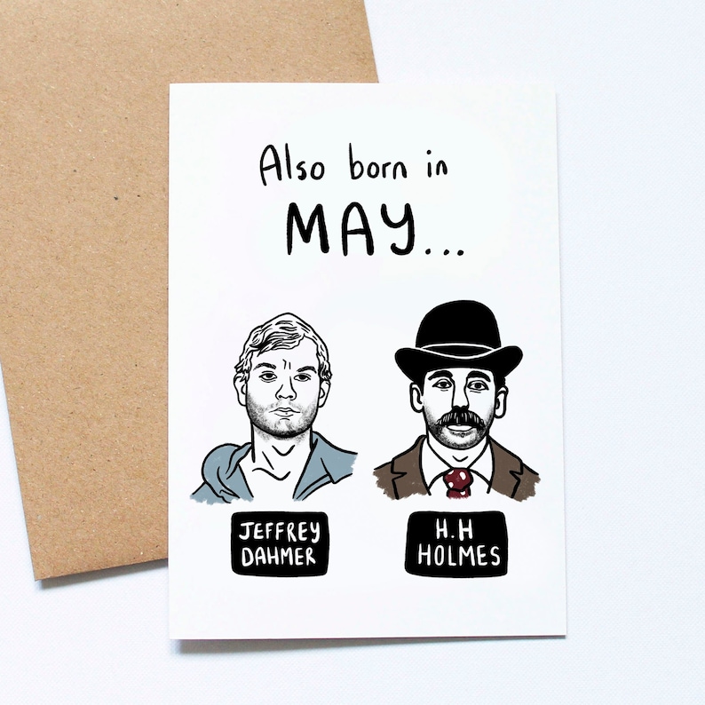 May include: A white greeting card with the text "Also born in MAY..." above illustrations of Jeffrey Dahmer and H.H. Holmes. The card has a brown envelope.