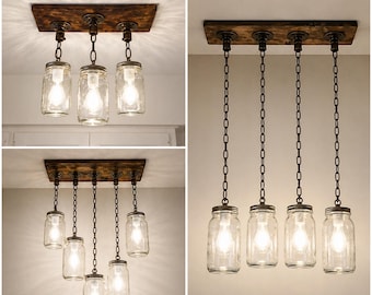 May include: A ceiling light fixture featuring clear glass mason jars suspended from a dark stained wooden rectangular base by black metal chains. The design incorporates multiple light bulbs housed within the jars, creating a warm glow.