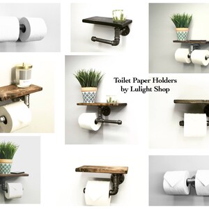 May include: A collection of rustic toilet paper holders. Each holder features a dark wooden shelf and industrial pipe fittings. Some include a single roll, while others hold two rolls. The text "Toilet Paper Holders by Lulight Shop" is visible.