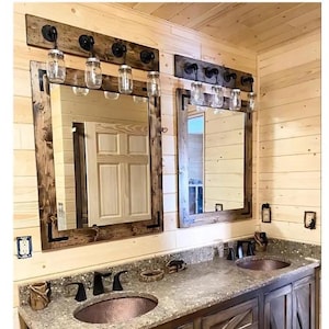 Farmhouse bathroom set with rustic wood mirror and vanity lighting
