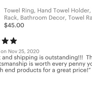 May include: A rustic wooden towel ring with a gray towel hanging on it. The ring is mounted on a wooden wall plaque. The product is described as a towel ring, hand towel holder, towel rack, bathroom decor, and towel rack. The price is $45.00.