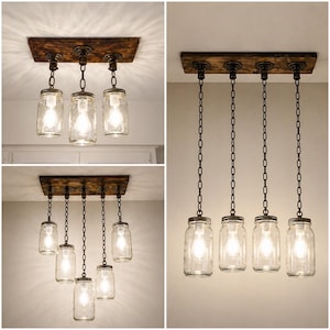 Farmhouse mason jar pendant light fixture with wood beam and chains hanging above rustic dining table in cozy kitchen