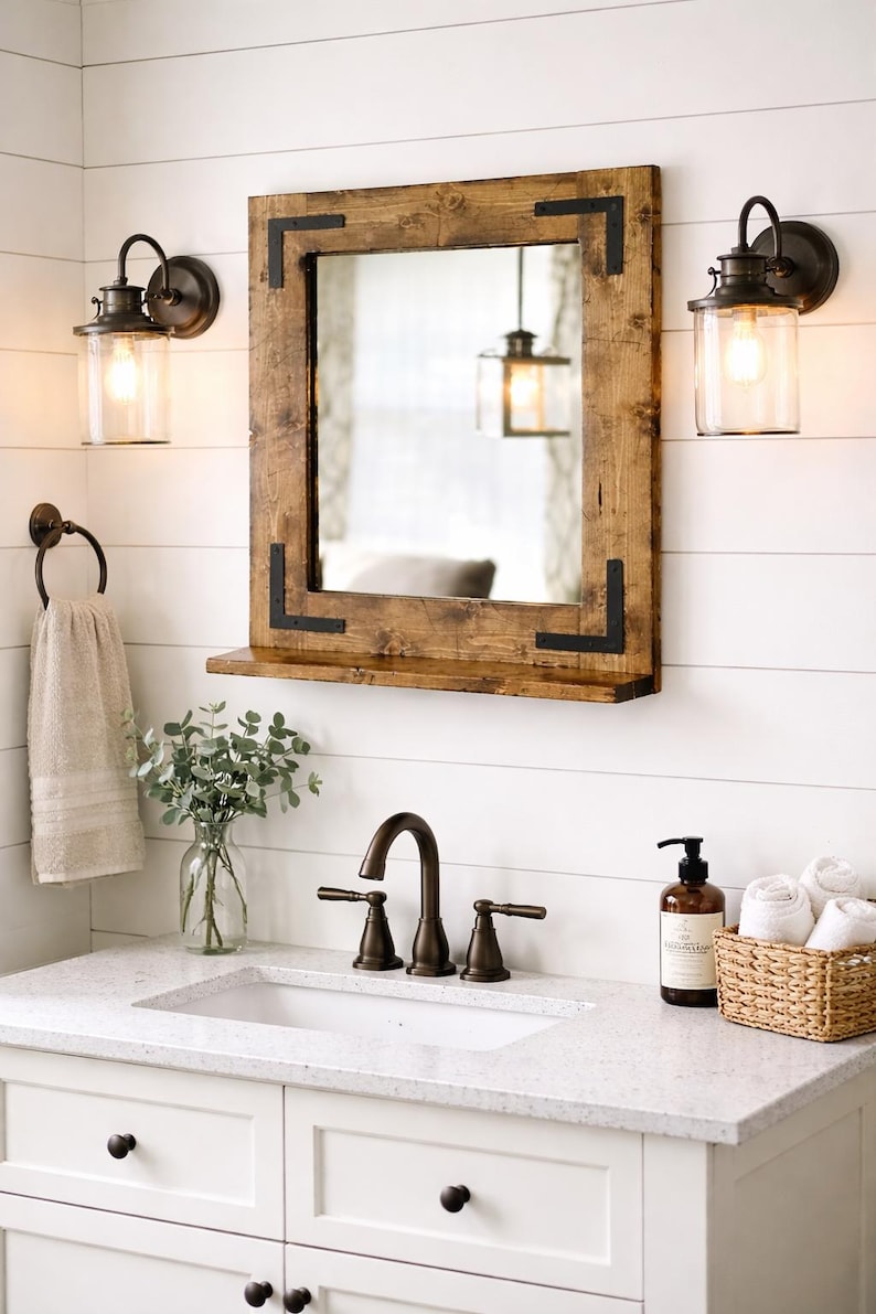 Handcrafted rustic wood framed mirror with a bottom shelf for storage, mounted on a bathroom vanity wall featuring a distressed finish and natural wood grain for a farmhouse-style charm.