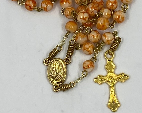 18" orange marbled bead rosary on gold with Madonna/Sacred Heart center