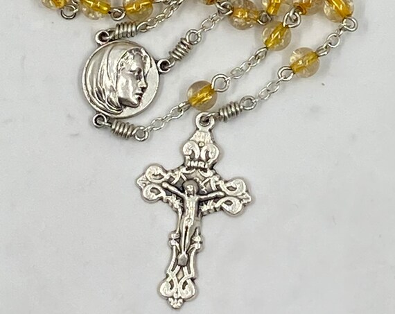 19"clear with honey glass bead rosary with Madonna center