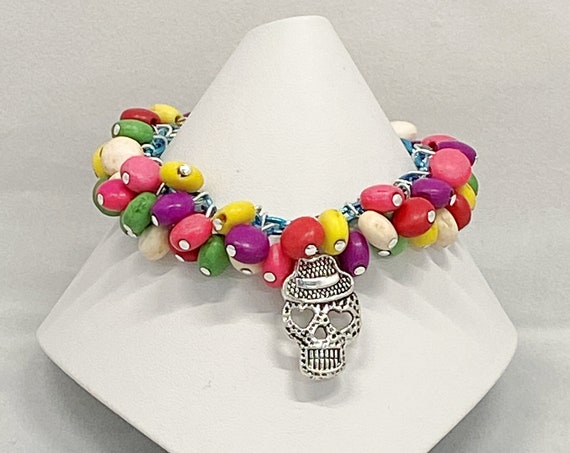 7" rainbow howlite and various skull charm bracelet