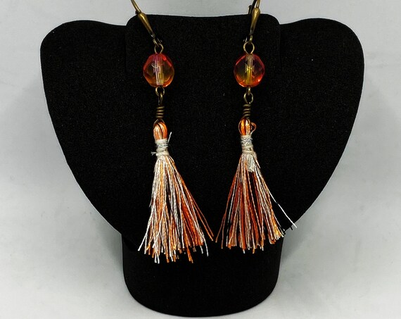 Orange, black, and white tassel earrings