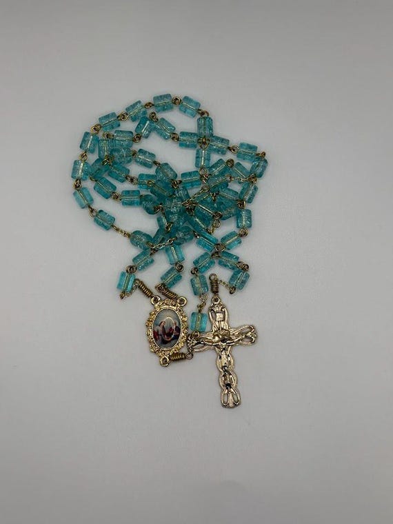 25" Aqua crackle glass bead rosary with Holy Trinity center and lily tipped crucifix